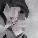 Hands unbox a luxurious Veto Lux diamond stud, revealing a sparkling lab-grown diamond in an elegant jewellery box, set against a soft, grey neutral background.