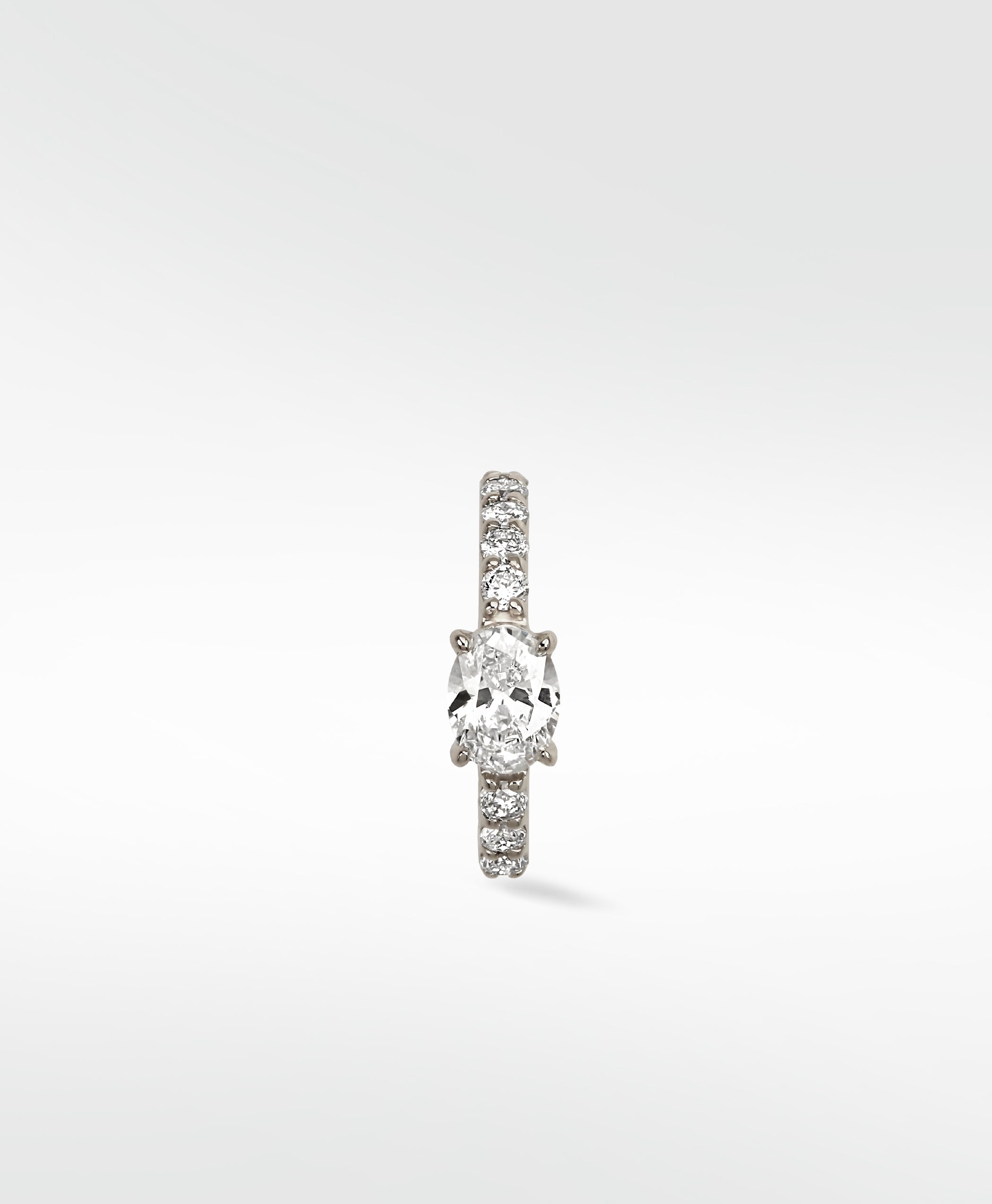Front view of the Lark & Berry Modernist Oval Diamond Hoop earring featuring a pavé diamond band set in white gold.